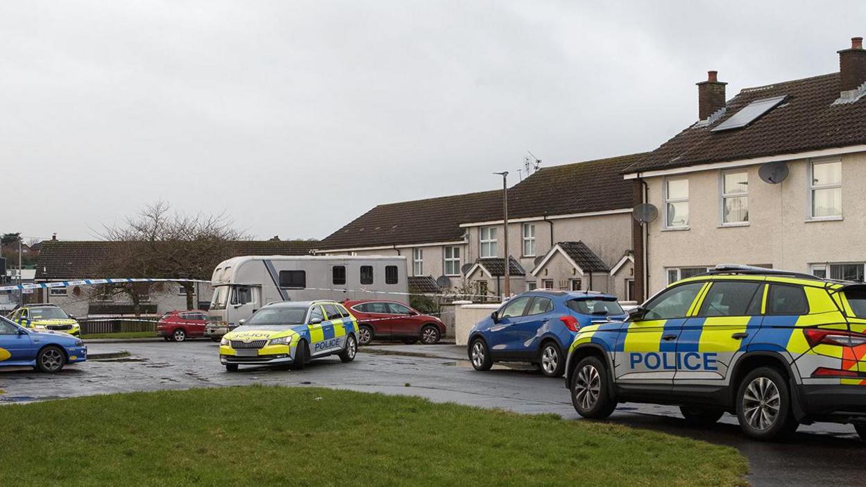 Yellow and blue police vehicle at Breezemount Close in Conlig