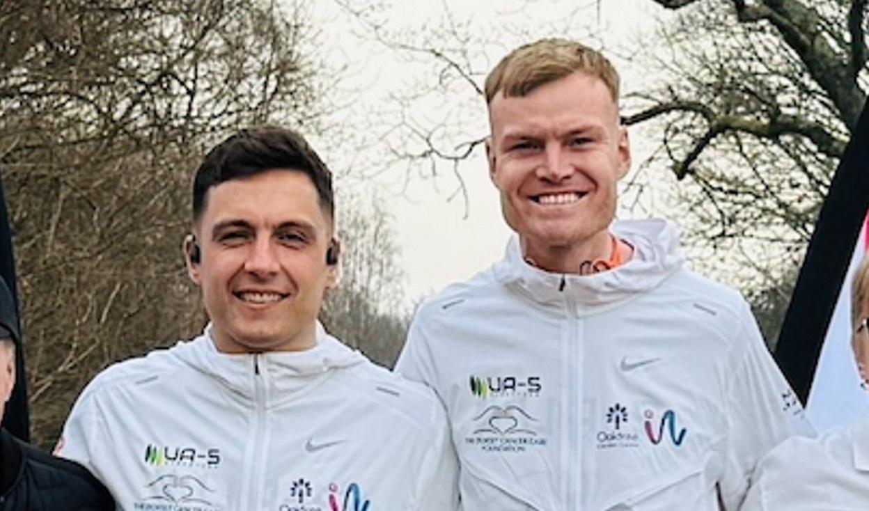 Chris Bryer-Ash and Chris Helberg posing side-by side in white charity training tops