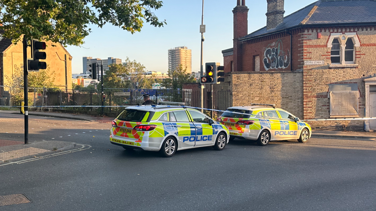 An officer and two police cars at the cordon in Ipswich
