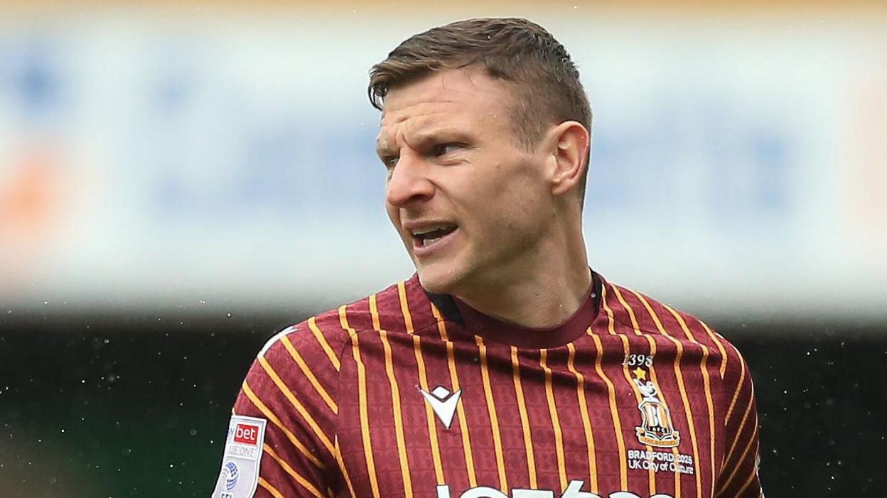 Paul Mullin in action for Bradford City in the club's claret and amber home shirt