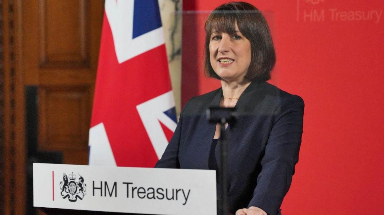 Chancellor of the Exchequer Rachel Reeves is giving a speech at the Treasury in London, Britain, to an audience of leading business figures and senior stakeholders. She is standing at a podium with with the words "HM Treasury" across the front