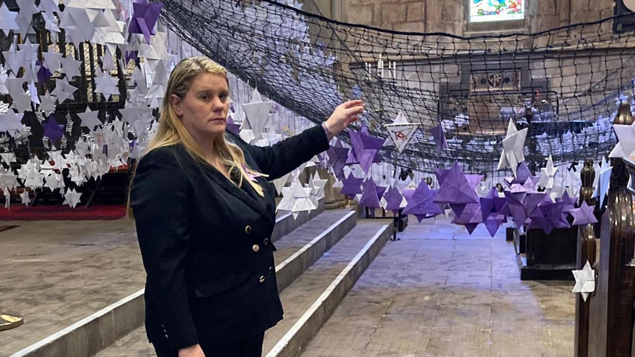 Holly's mother Micala Trussler with some of the purple stars created in memory of her daughter