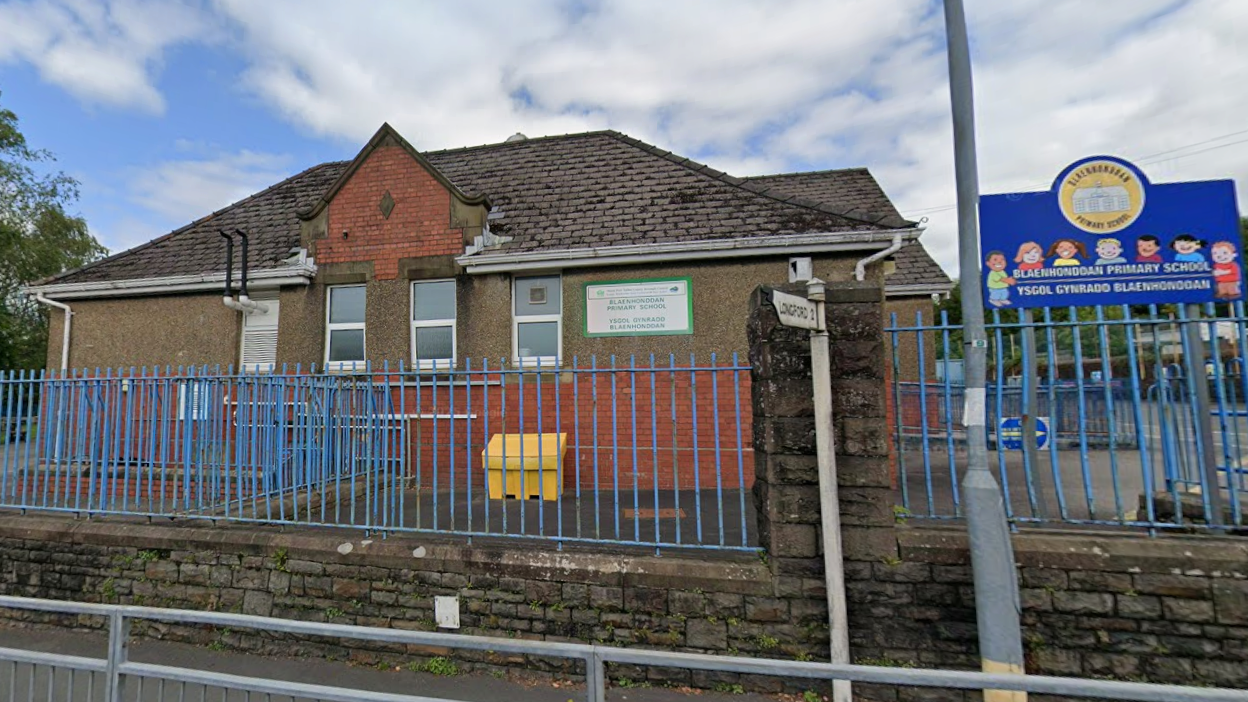 Bleanhoddan Primary School seen from the outside. It is a brick building with railings around the perimeter