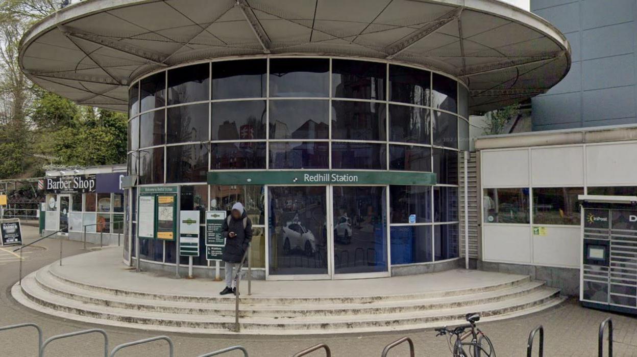 The front of Redhill station with a man outside