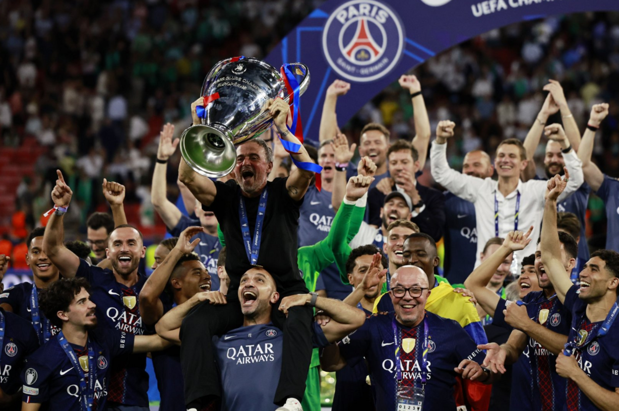 Paris St-Germain's head coach Luis Enrique and his players celebrate with the trophy after winning the UEFA Champions League final 