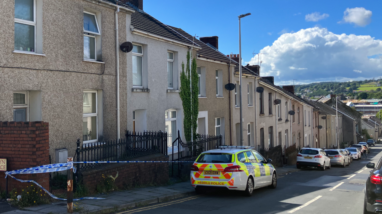 A police car and police tape near a house in Bigyn Road, Llanelli, after the discovery of Sophie Evans's body