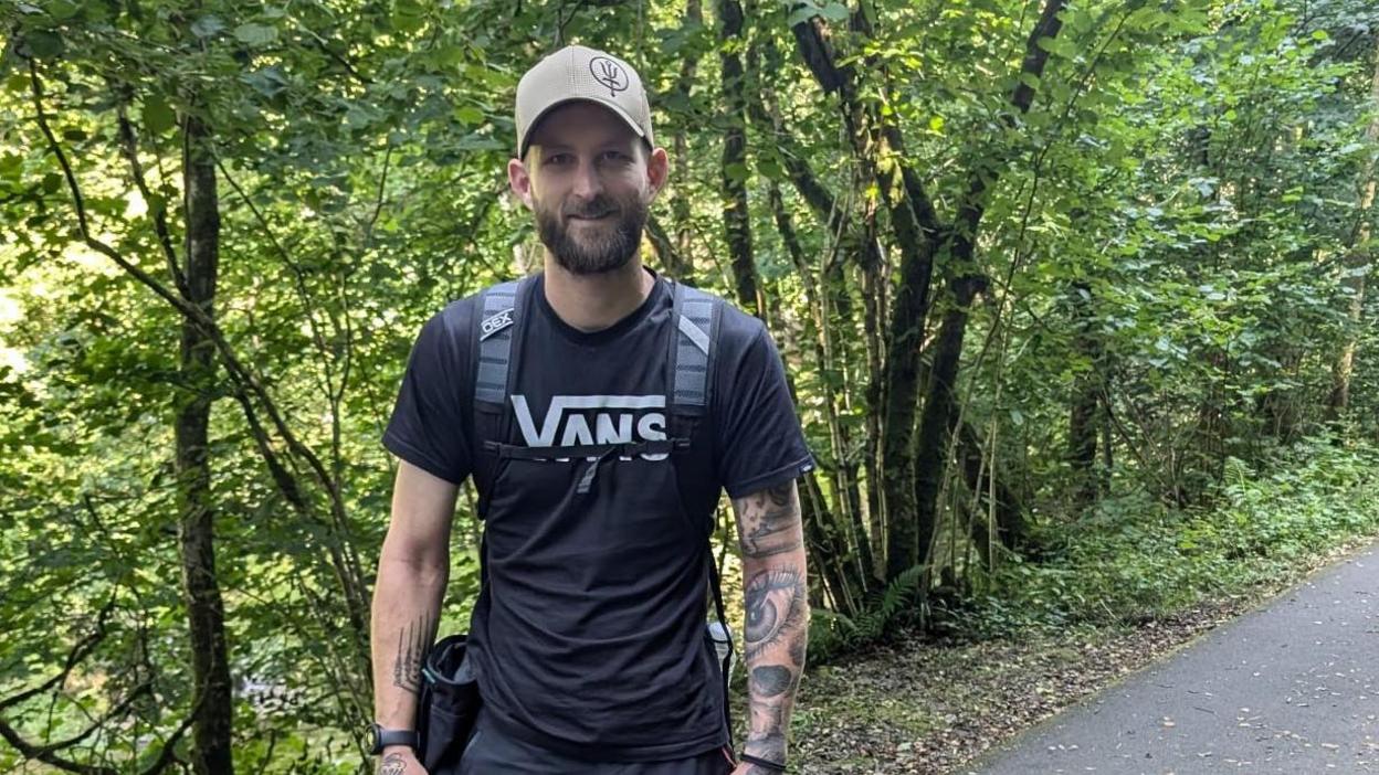 Mr Kendall is pictured walking along a track 