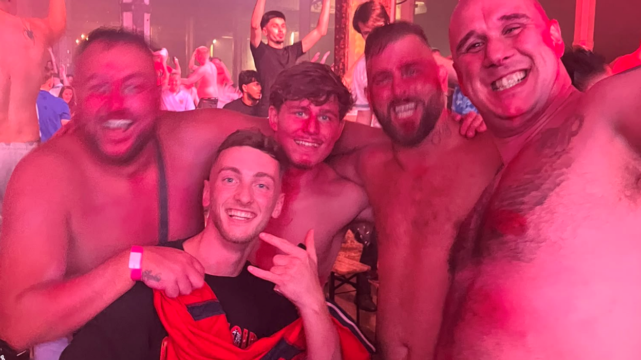 Sean, far left, celebrating England's winning run with friends in a darkly lit outdoor fanzone