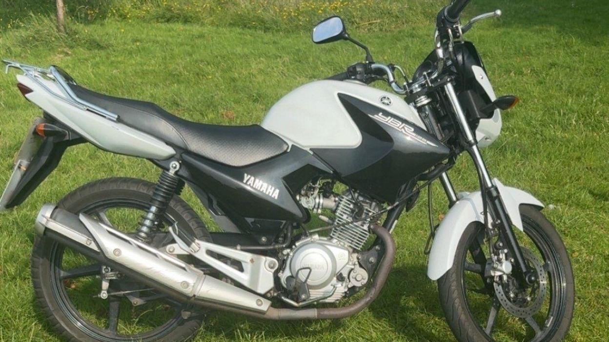 A photograph of the stolen Yamaha motorbike parked on grass