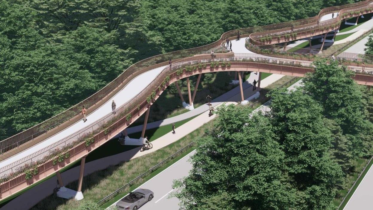 A CGI image of the proposed bridge. People can be seen walking on the bridge and cycling on a lane underneath it. There is a car on the road alongside the cycle lane.