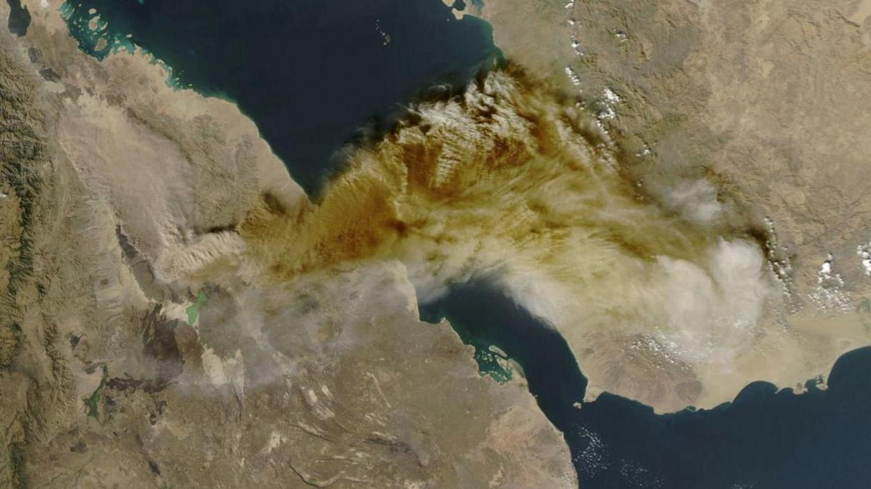 A satellite image shows ash rising from the eruption of the Hayli Gubbi volcano in Ethiopia as it drifts over the Red Sea. 
