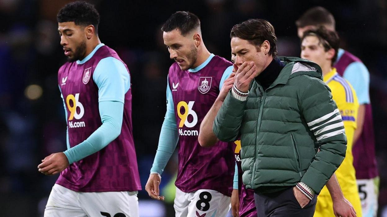 Burnley manager Scott Parker and his players leave the field at Turf Moor