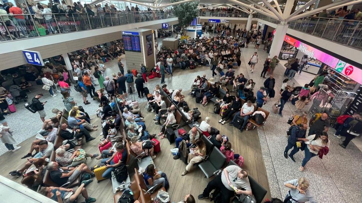 A view from above of a very busy Bristol Airport departure lounge