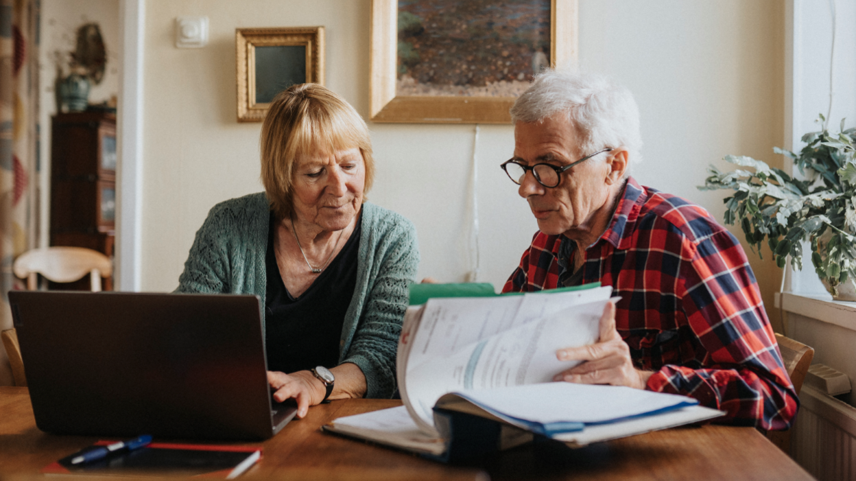 Senior couple using laptop at home 