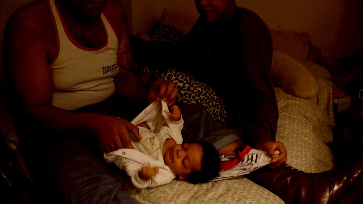 Man with baby in guardian scheme