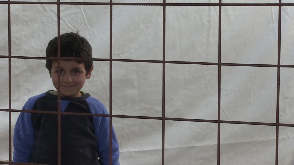 Child behind a barrier