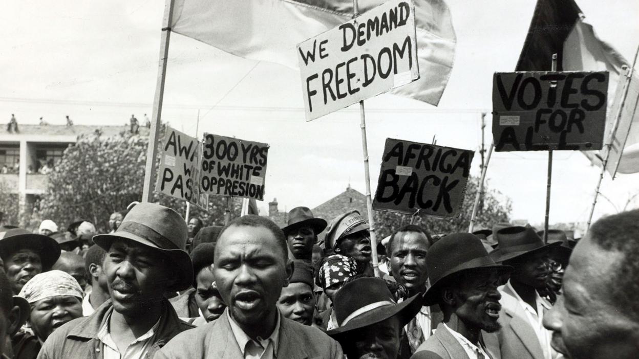 Black African protesters seen among a crowd at a Johannesburg protest meeting.