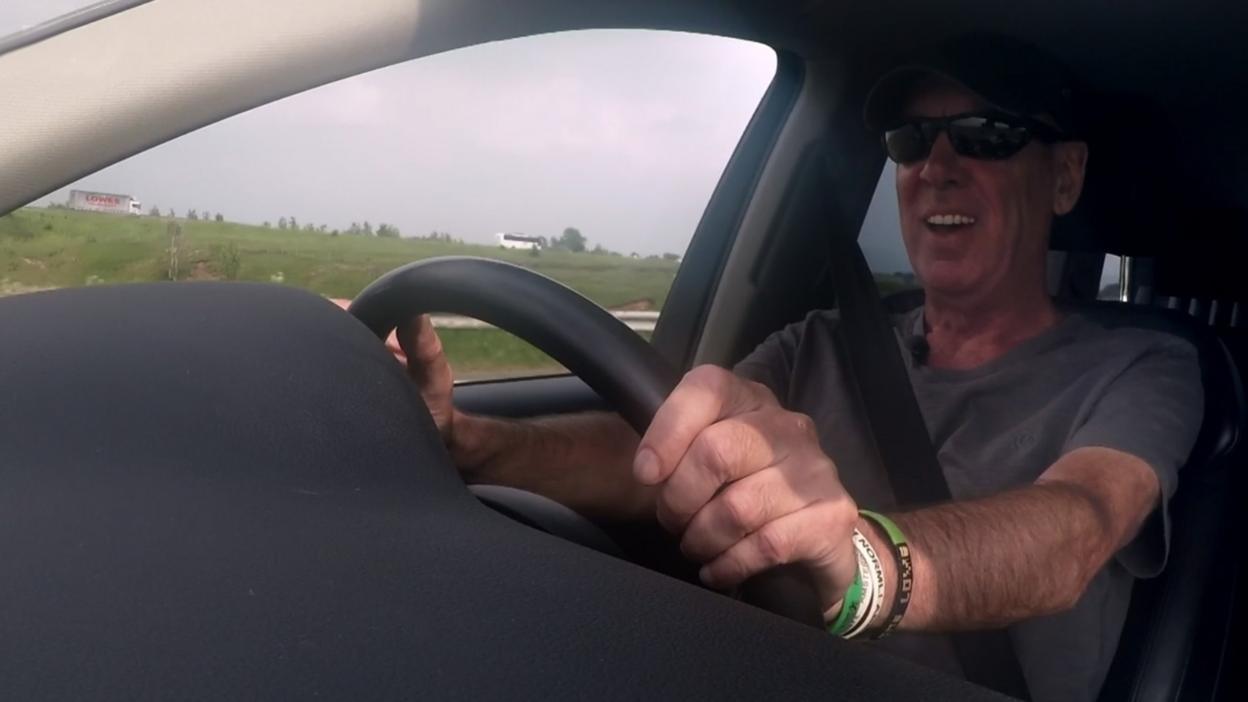 Jeff driving in his car