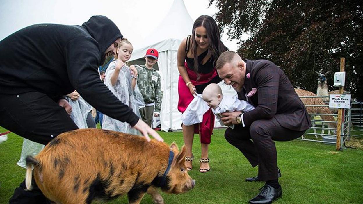 Conor McGregor with girlfriend Dee Devlin and son Conor Jr with pig