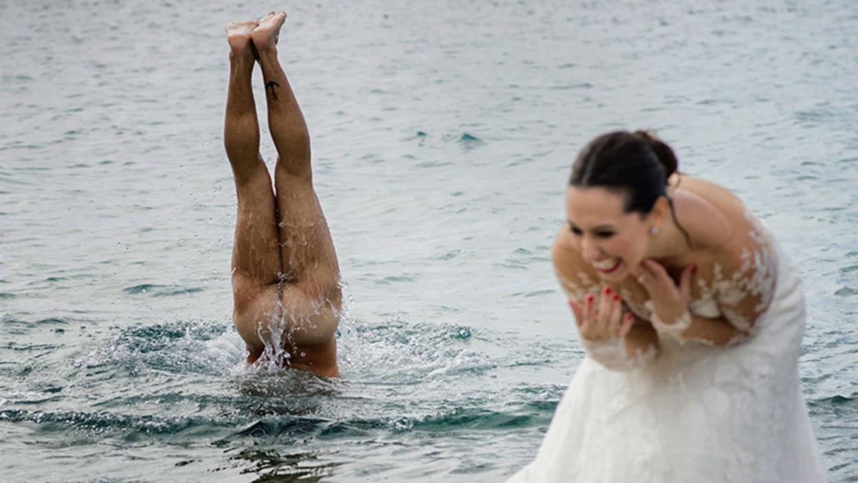 Man skinny dipping as bride laughs