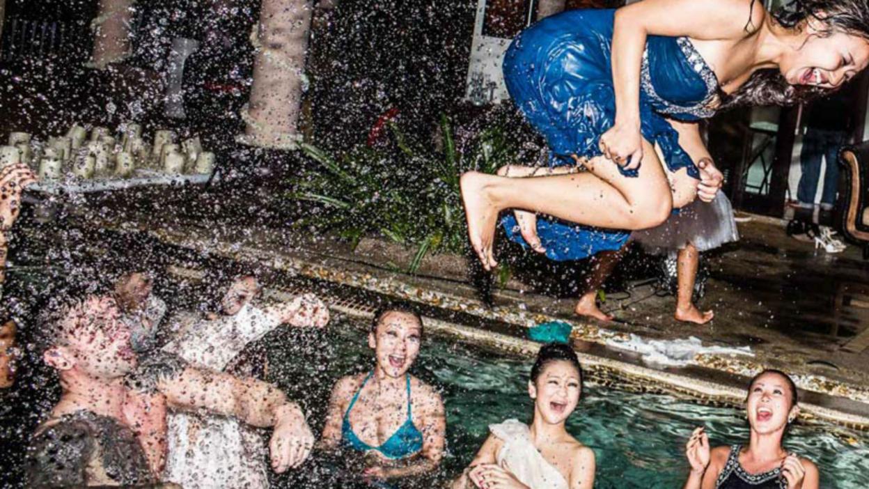 Bride jumping into pool with bridesmaids