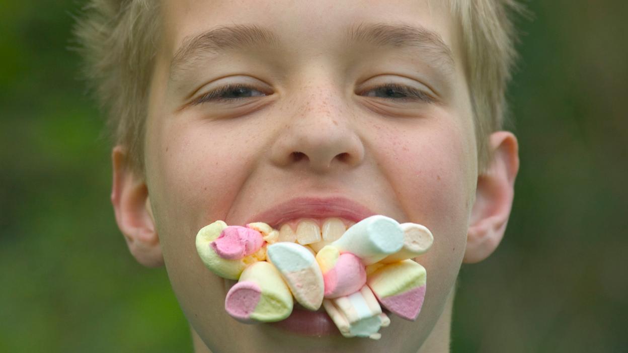 Kid with a mouthful of marshmellows