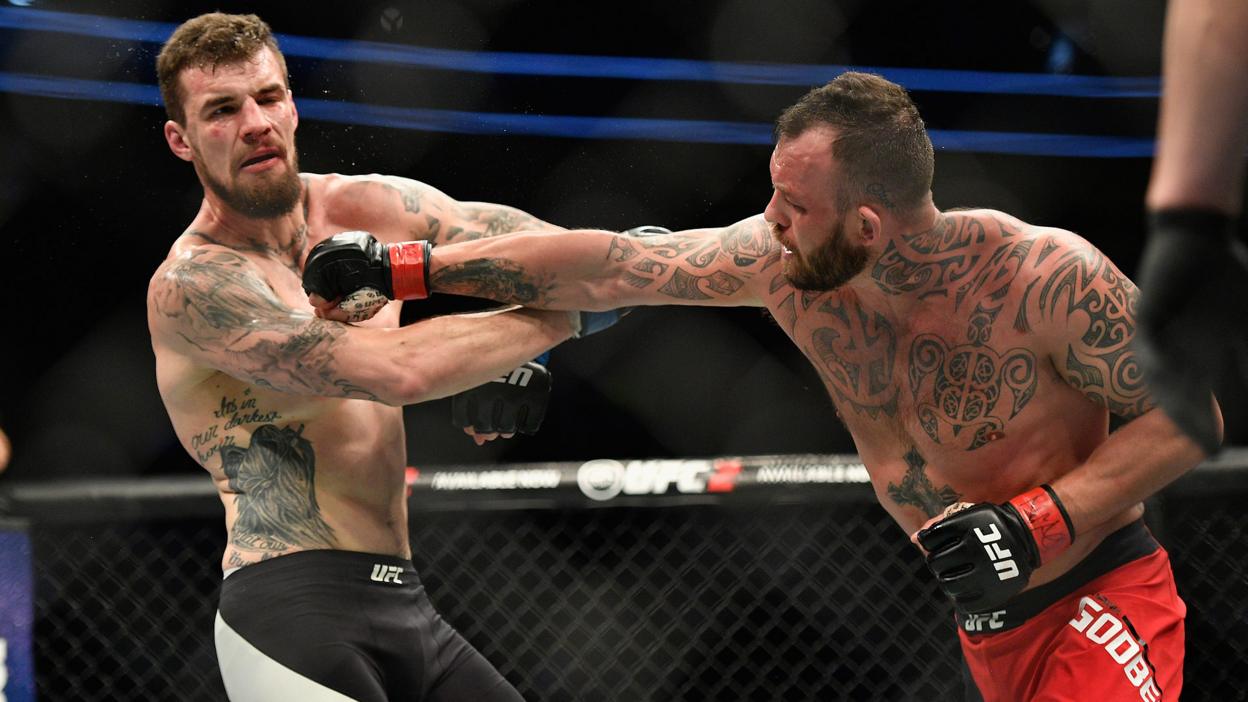 Mark Godbeer tries to land a strike on Daniel Spitz at UFC 209