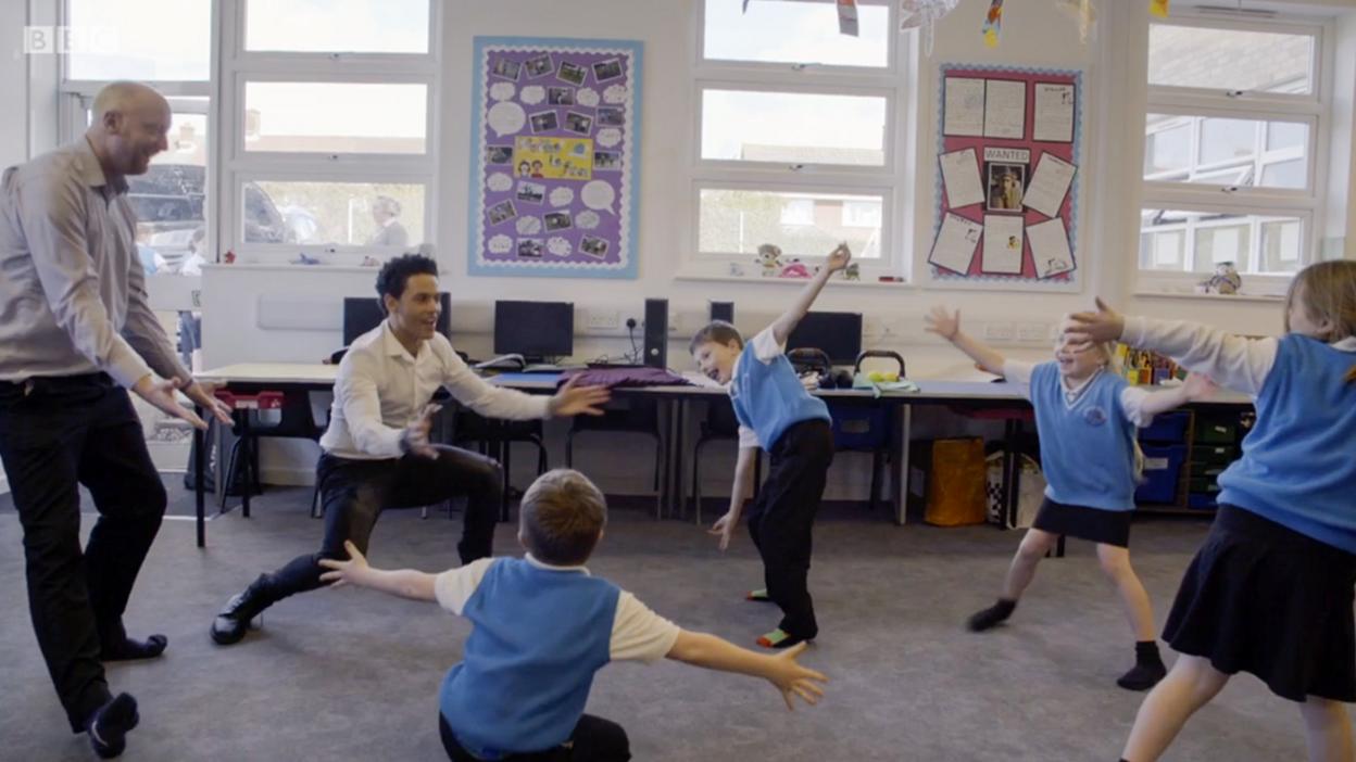 A male ballet dancer came to the school to meet the children.