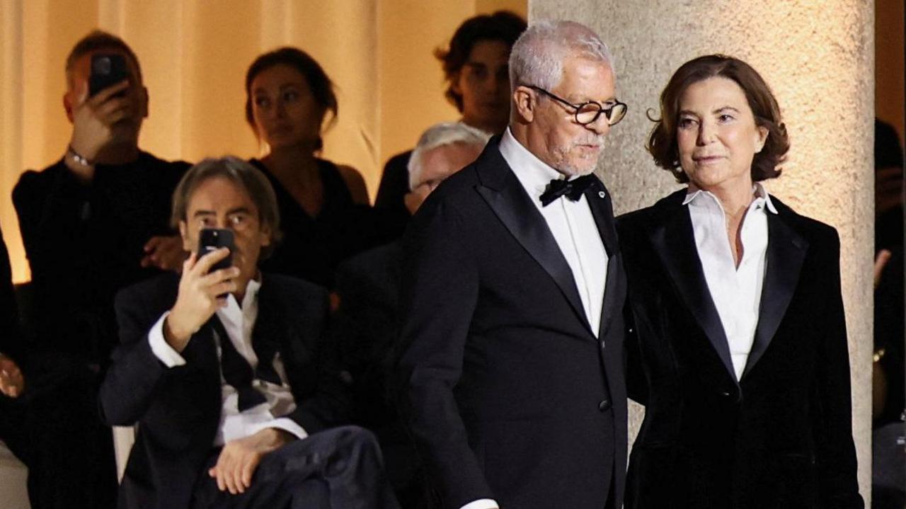 Leo Dell'Orco, head of Men's Style at Armani Group, and Silvana Armani, niece of late fashion designer Giorgio Armani, appear at the end of the Giorgio Armani Spring/Summer 2026 collection show during Fashion Week in Milan, Italy, September 28, 2025.