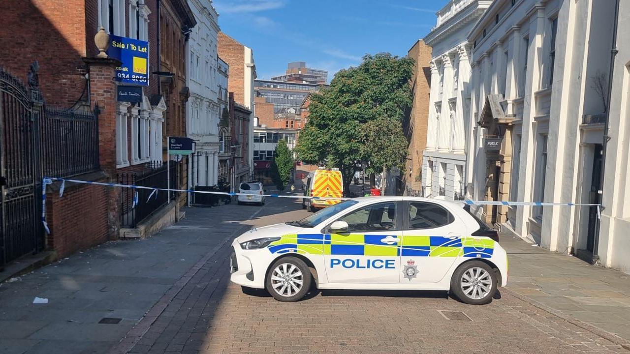 Police cordon and police car in Hounds Gate, in Nottingham