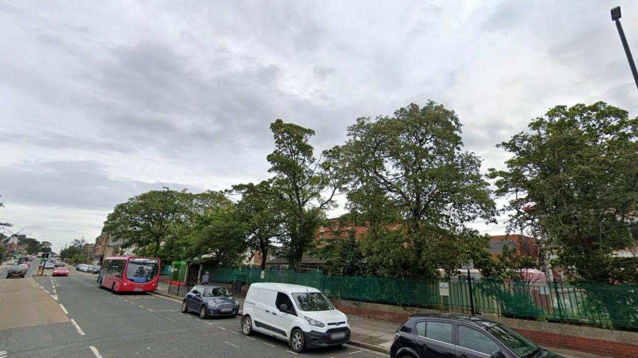 Google Street View photo of Newcastle Road. There are buses are cars on the side of the road. 