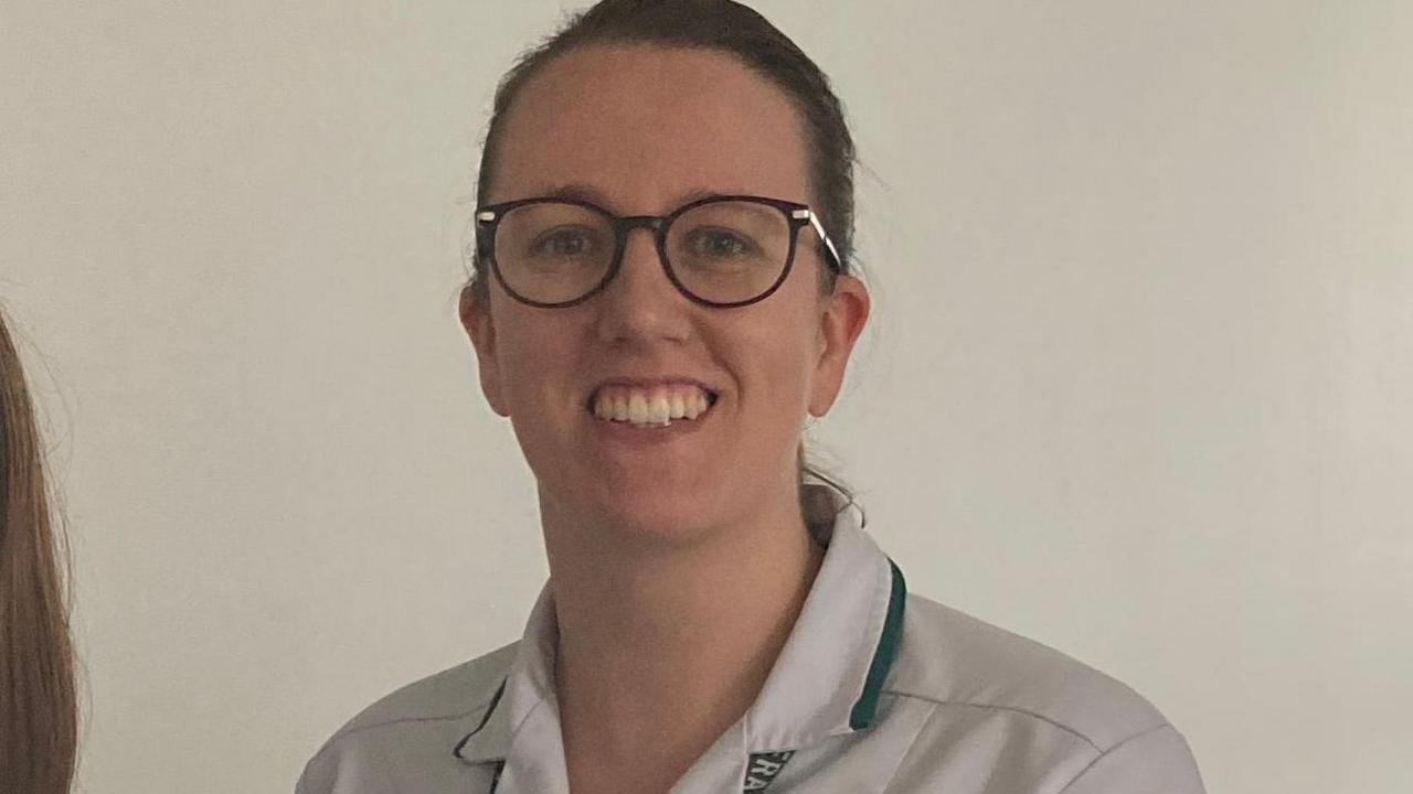 Occupational therapist Anna Marshall in her uniform, looking directly at the camera