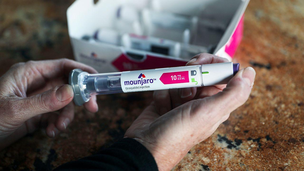 A close up of a persons hands holding the packaging for a Mounjaro injection, taken in California in 2023.