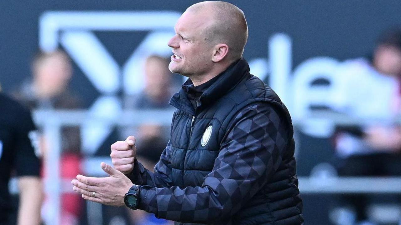 Bristol City head coach Liam Manning delivers instructions to his team