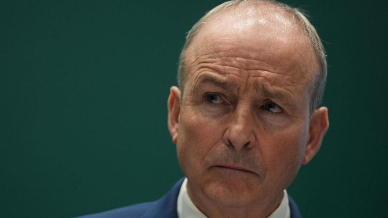 Micheál Martin, a man with grey hair, a blue jacket and white shirt.
