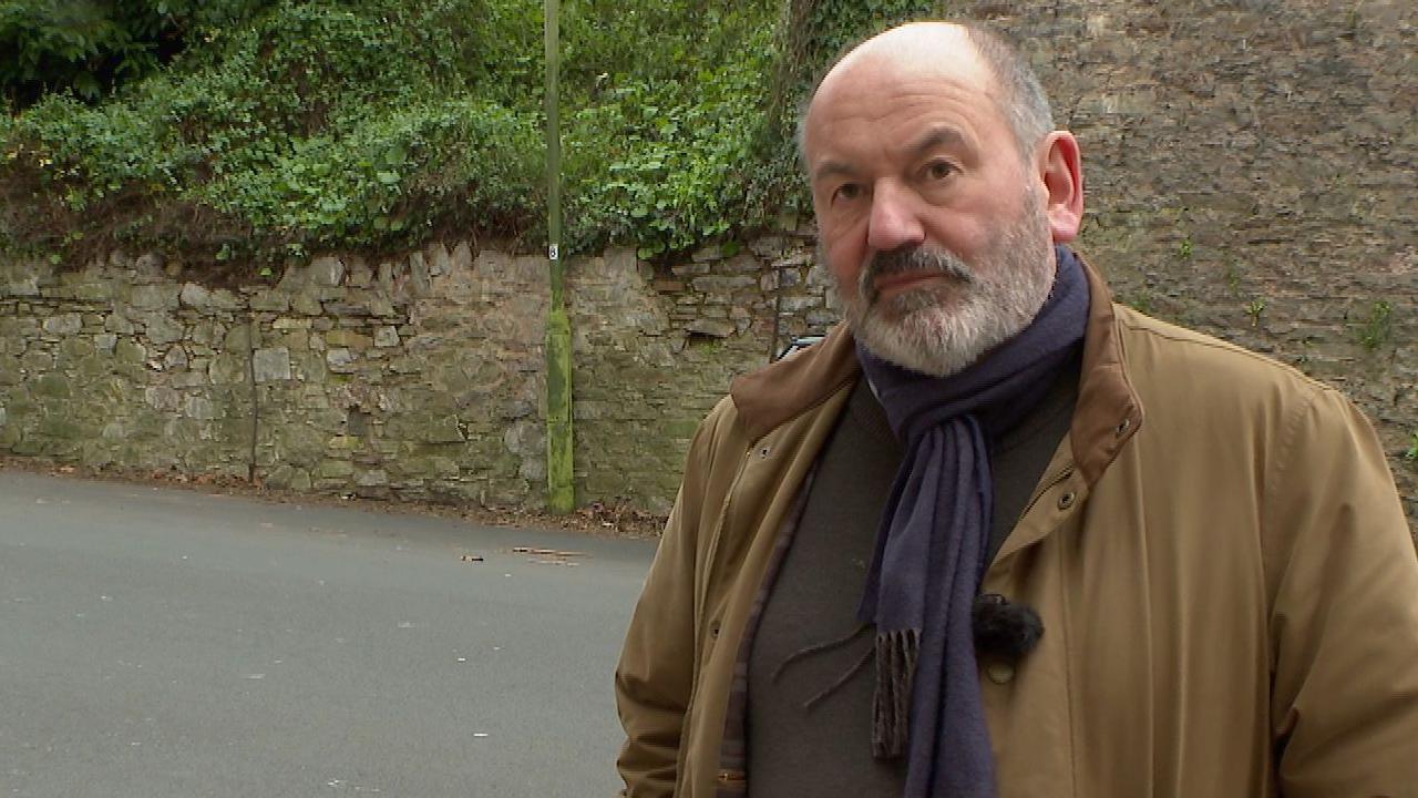 Mick Randall standing in Mill Lane, Torquay, where Richard Locker was last seen. He has a sandy coloured coat and purple scarf. 