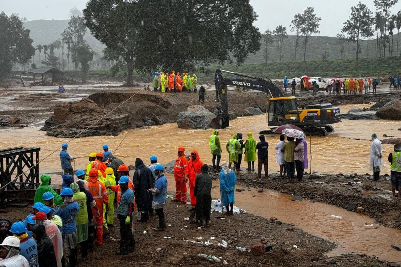 Rescue workers seen using heavy machinery to move a boulder