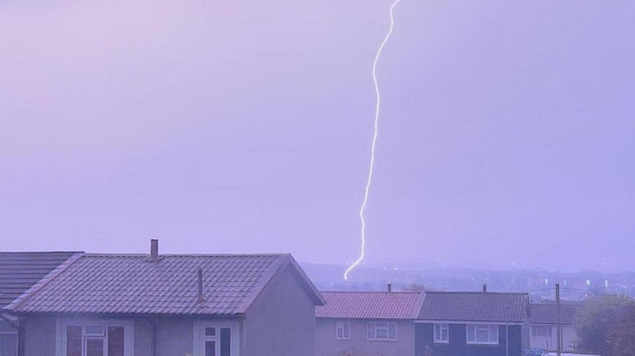 A vertical lightning strike crashes down above houses in Portsmouth