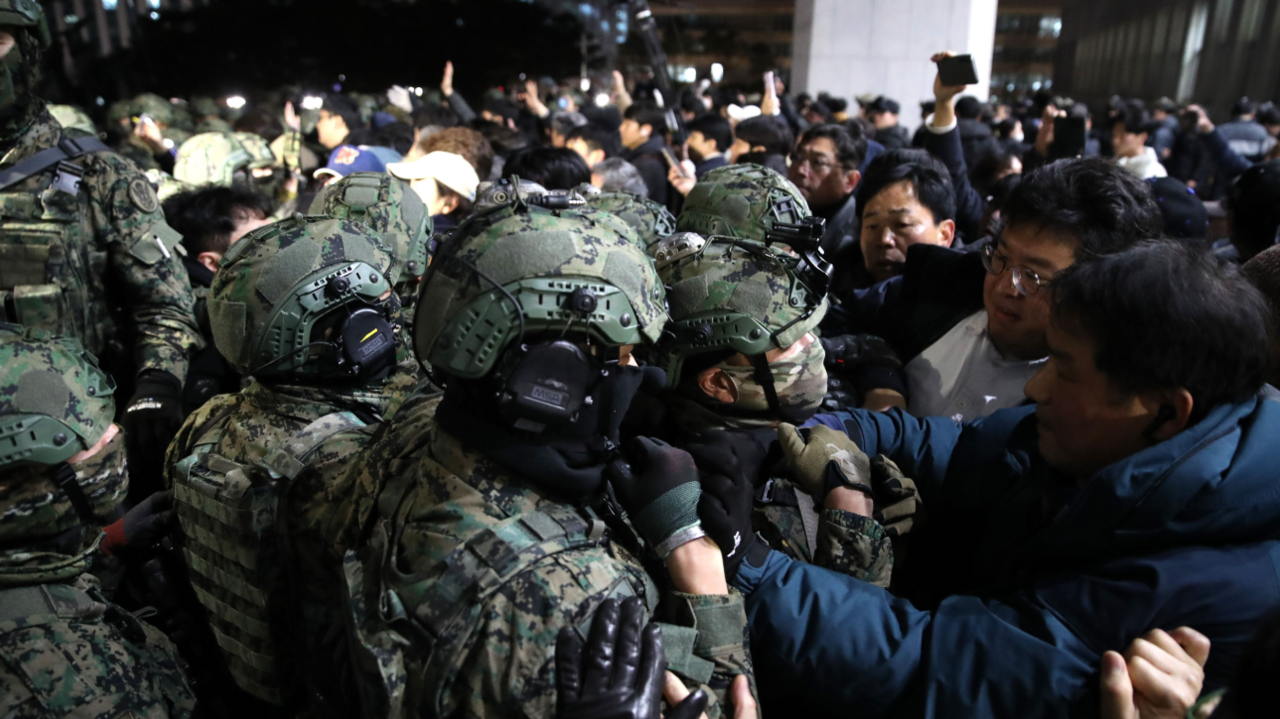 Soldiers in South Korea try to detain protesters during the imposition of martial law