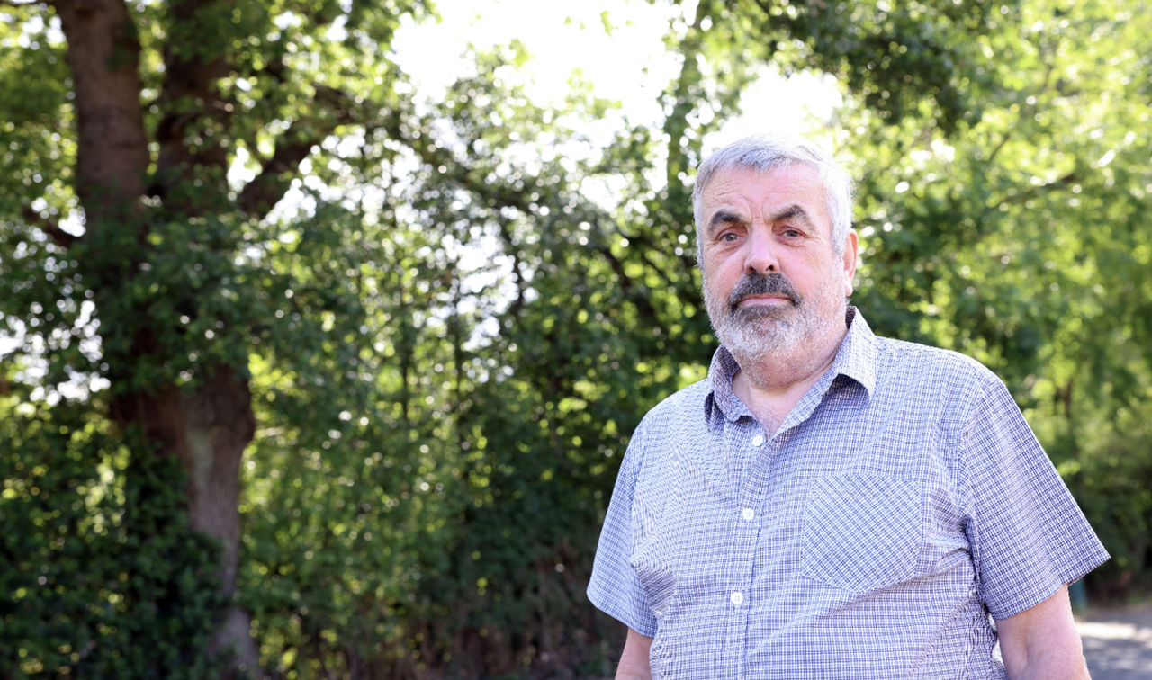 Paul Burns standing next to the 'dangerous' tree branch