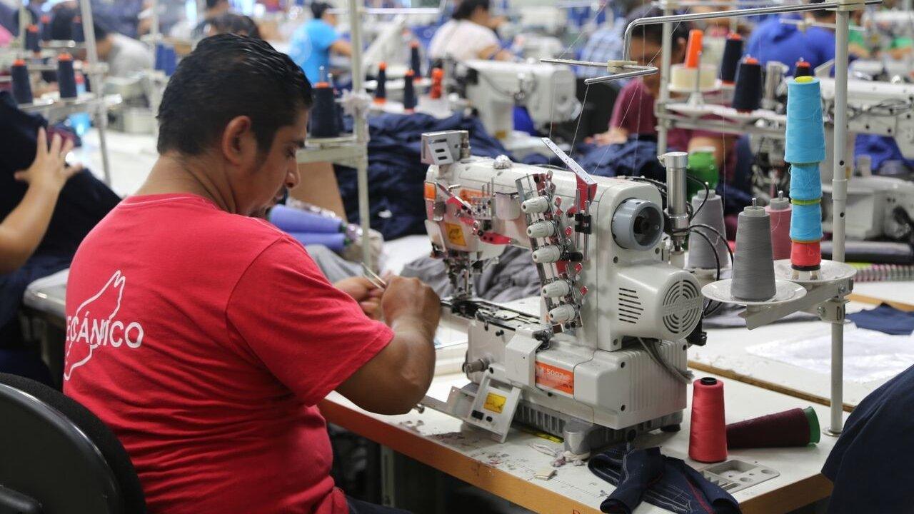 Man at sewing machine in factory (July 2015)