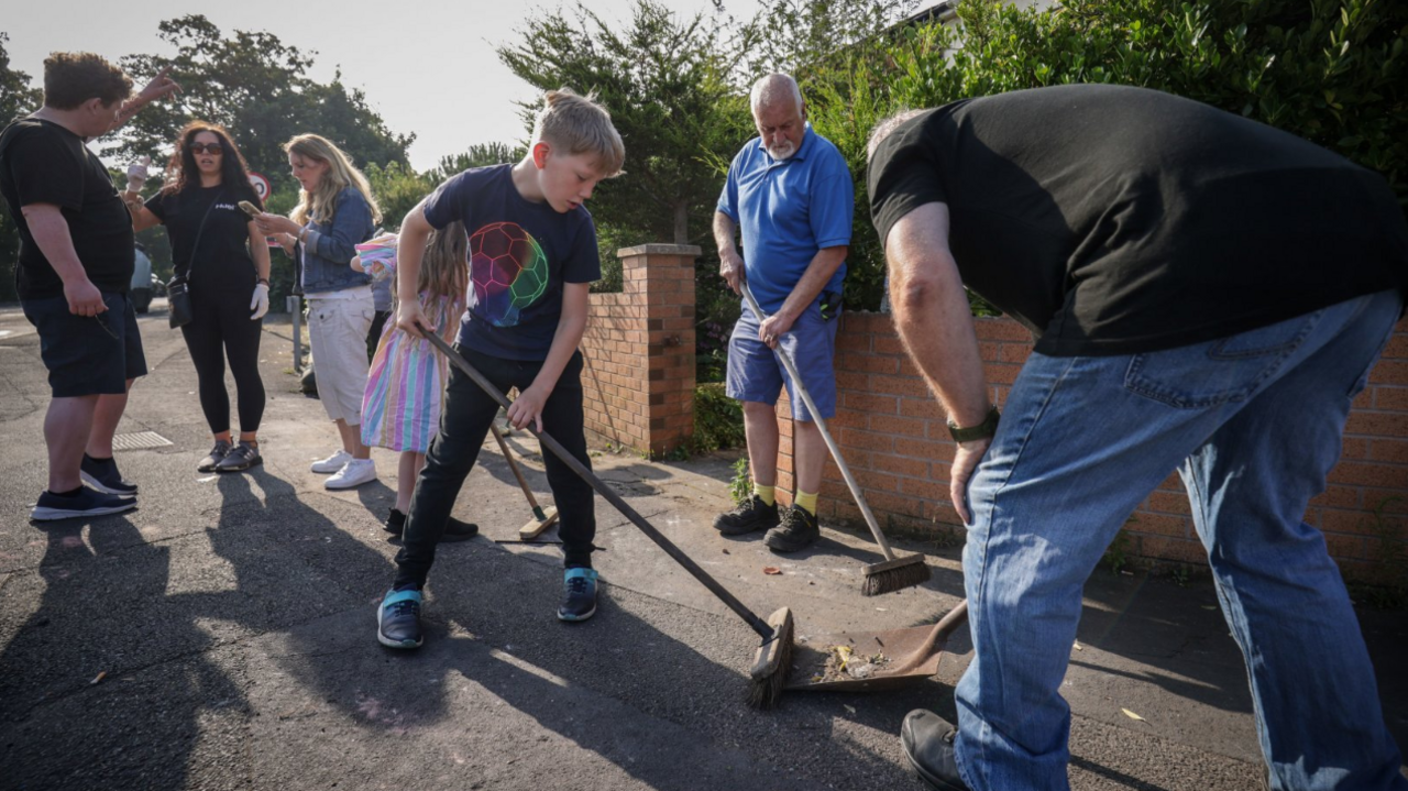 Volunteers in Southport help clean up debris left after violent scenes