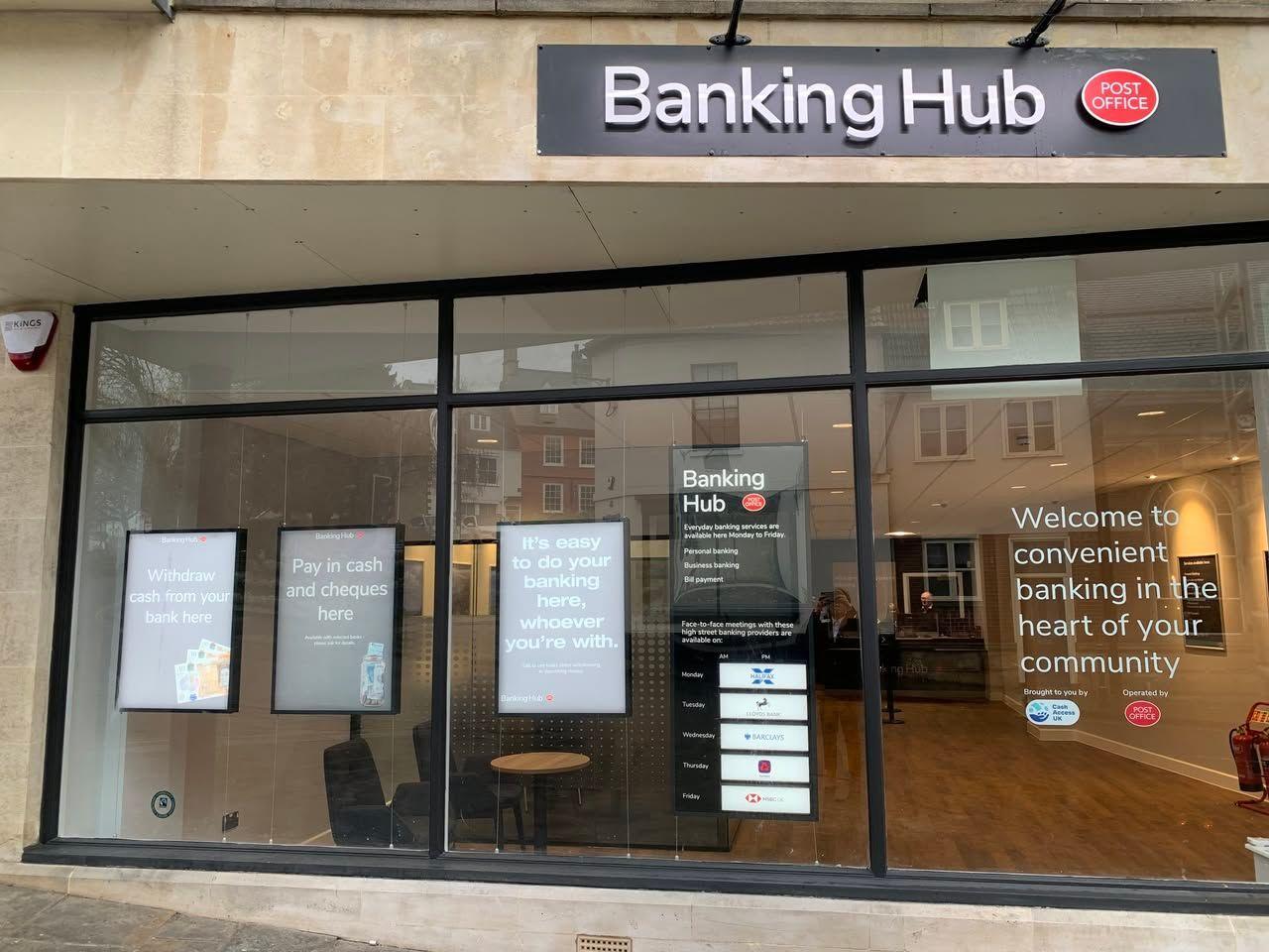 A sandstone building with large glass windows, with 'Banking Hub' and the Post Office logo above it.