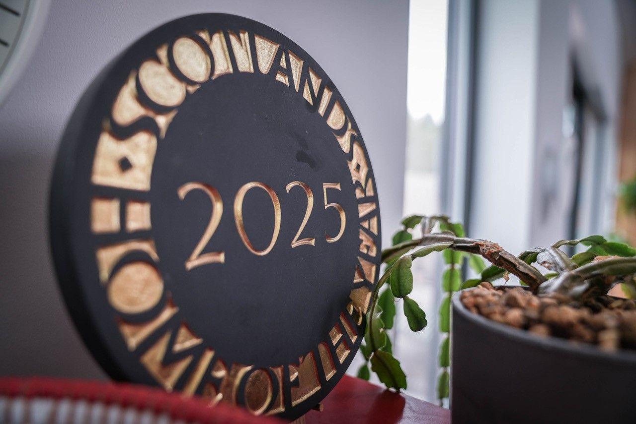 The winners' plaque sits in the kitchen - it is a large circular carving in black, inlaid with gold letters saying "Scotland's Home of the Year 2025".