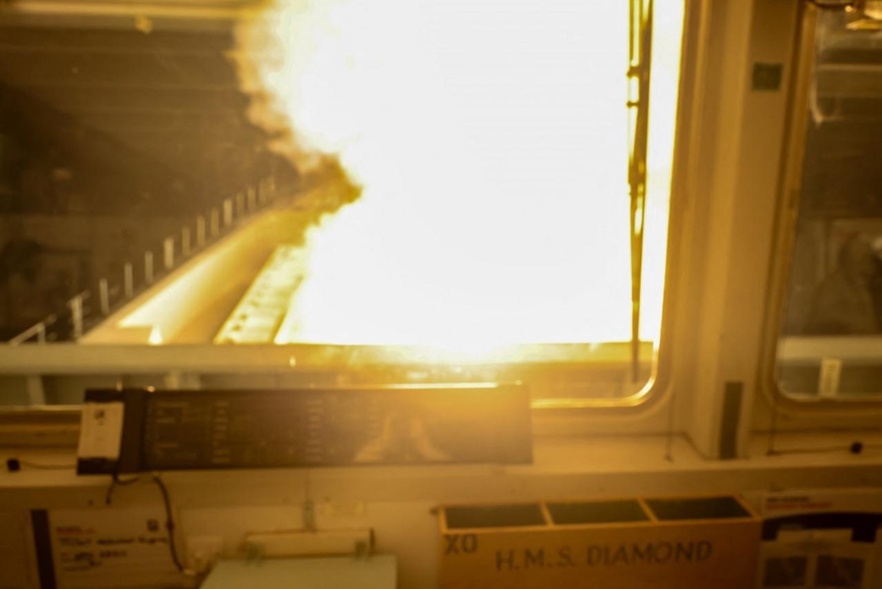 Fire in window of the bridge of the naval ship HMS Diamond