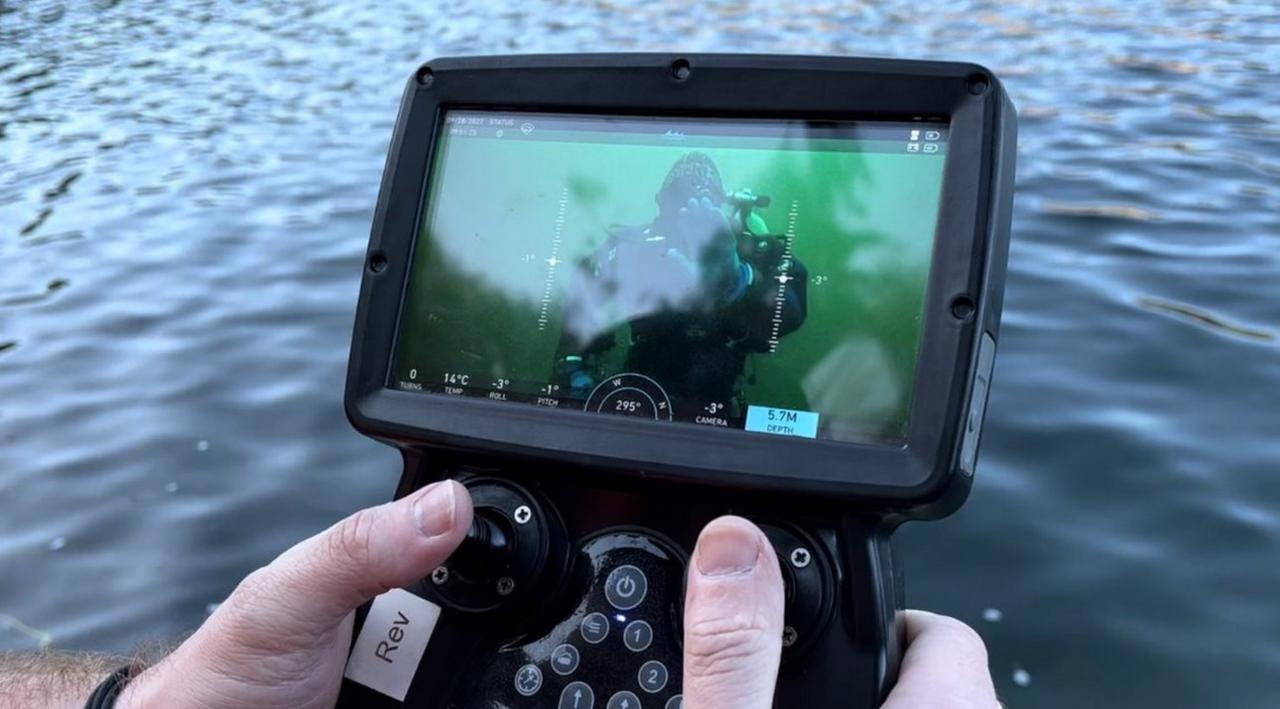 A camera showing Dan underwater