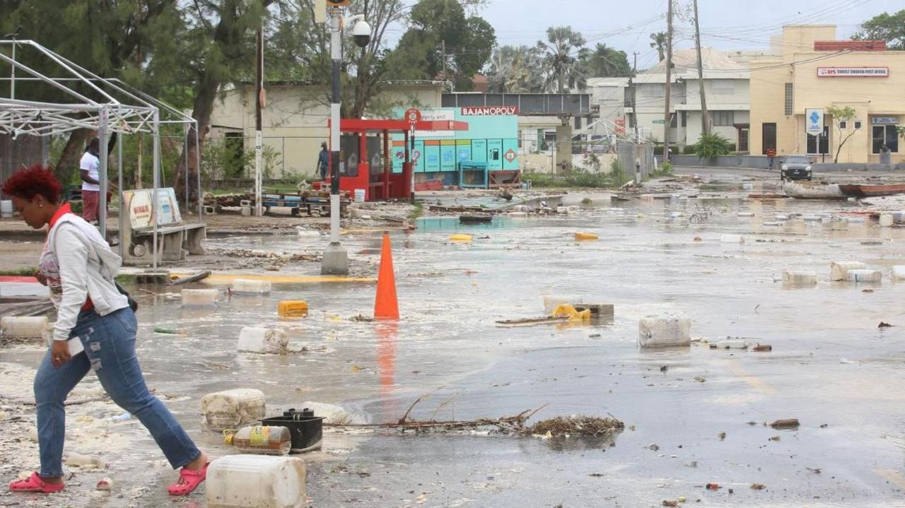 A woman walks through a debris-filled street in the Hastings neighbourhood after Hurricane Beryl passed in Bridgetown, Barbados 