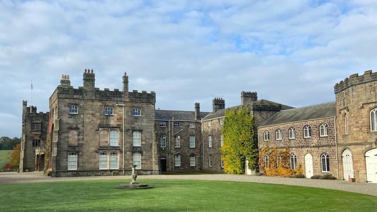 The Ripley Castle estate close up, the open grass area with stone statue is visible in front of the property