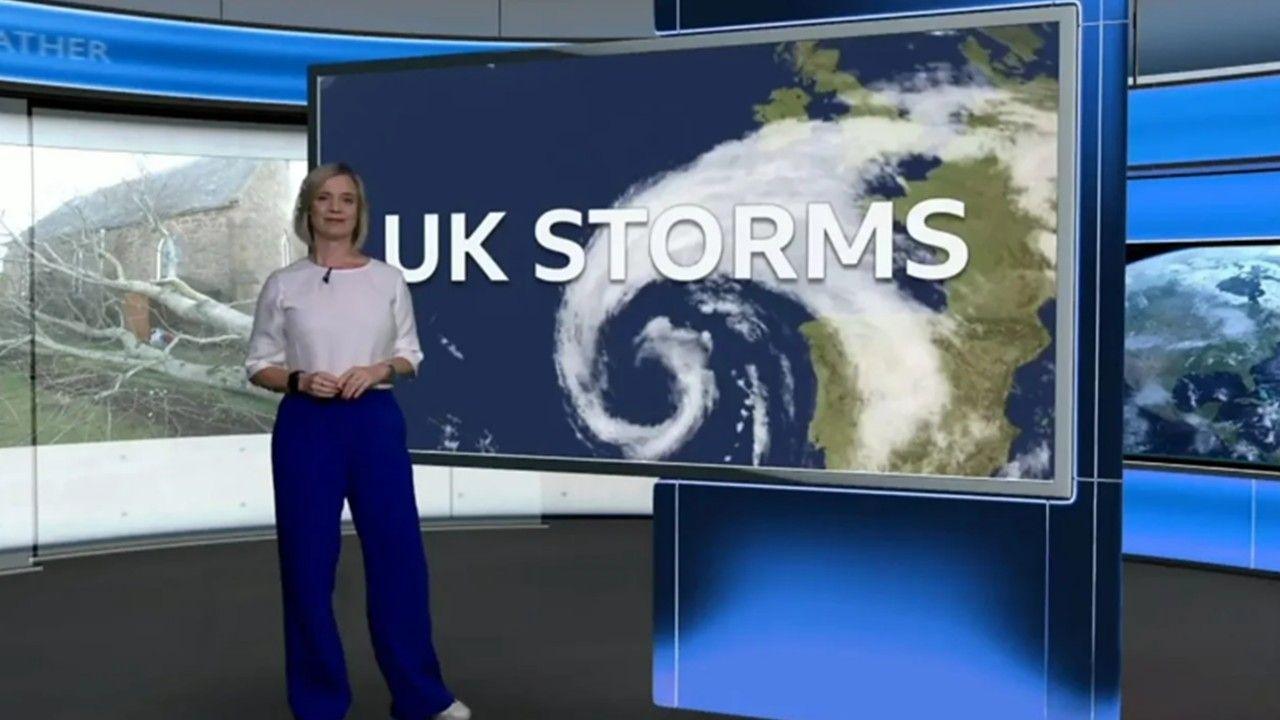 Sarah Keith-Lucas stands in front of a TV screen with the words UK Storms written on it