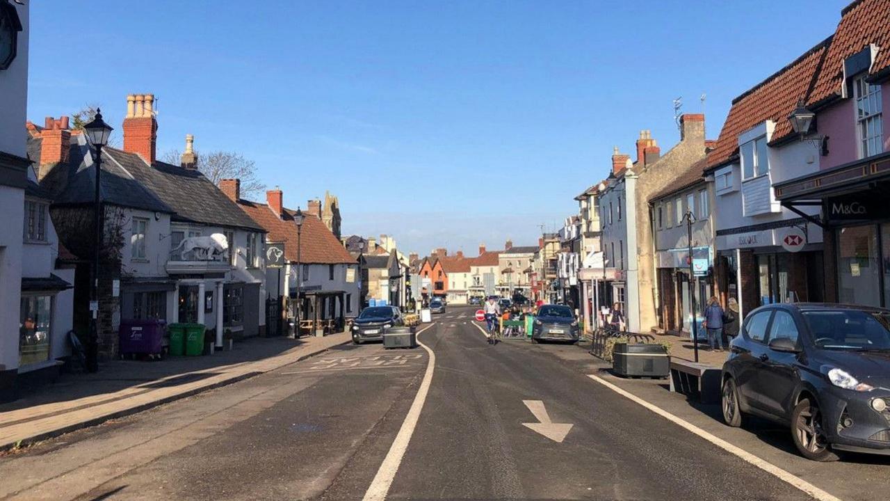 A cyclist and shops on Thornbury High Street